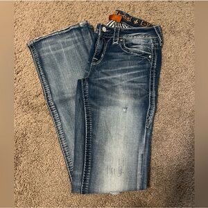 Rock Revival bootcut mid rise distressed jeans.